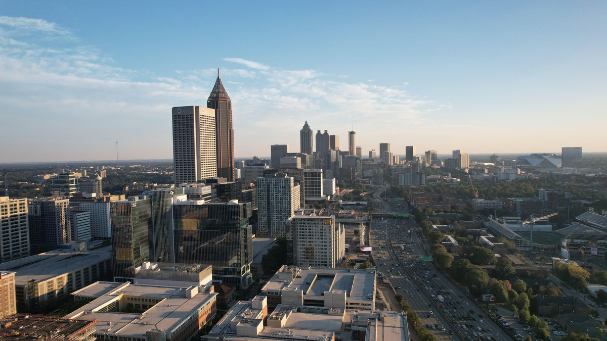 Aerial view of the Atlanta skyline and highway corridor.
